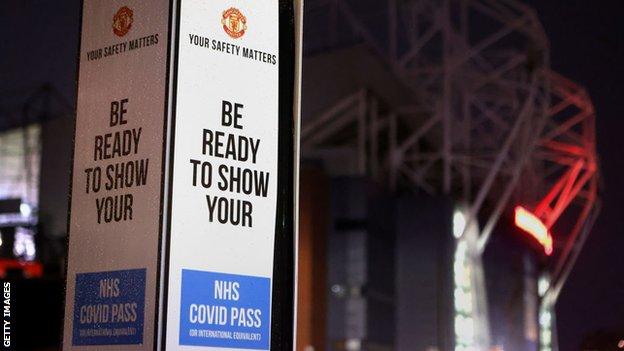 A Covid-19 pass information sign outside Manchester United's Old Trafford