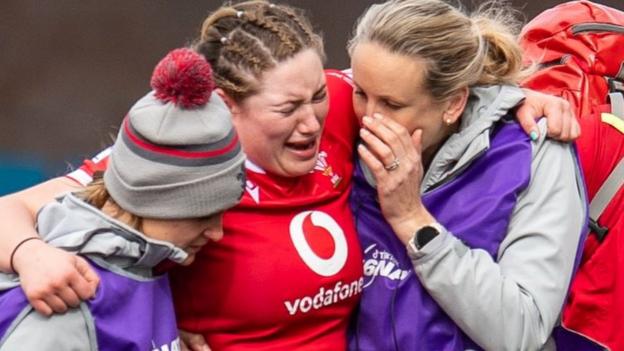 Gwen Crabb is helped from the field during Wales' win over Ireland