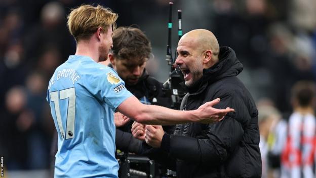 Manchester City's Kevin de Bruyne celebrates with manager Pep Guardiola at full-time after they beat Newcastle United