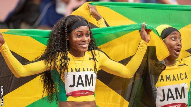 Elaine Thompson-Herah and Shelly-Ann Fraser-Pryce celebrate winning the 4x100m at the Tokyo Olympics