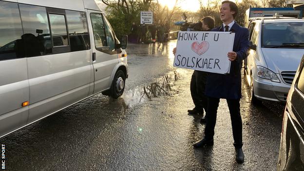 A Norwegian broadcaster holding up the placard