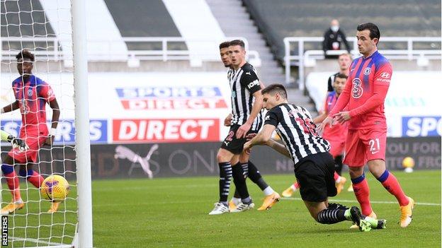 Newcastle defender Federico Fernandez scores an own goal against Chelsea while under pressure from Ben Chilwell