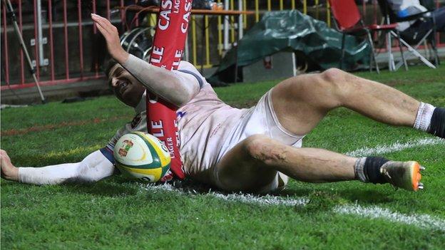 Jonny May slides into a touch in goal flag after scoring for England