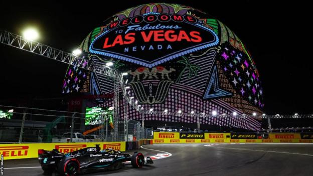 George Russell drives past the sphere which lights up with the las vegas sign