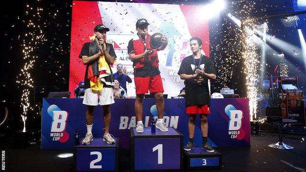 Peru's Francesco De La Cruz celebrates on the podium with his medal after winning the First Balloon World Cup with second placed Germany's Jan Spiess and third placed Spain's Jan Franquesa