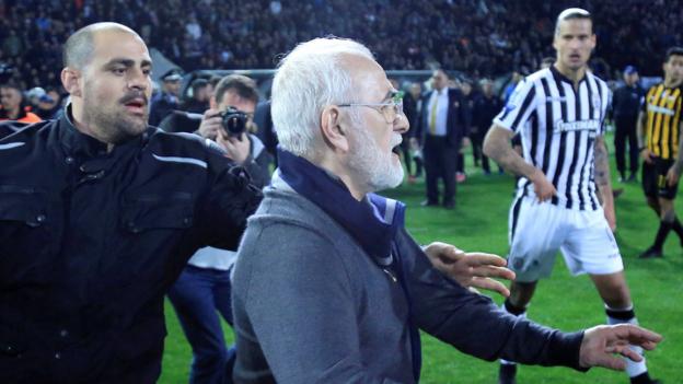 President of Greek club PAOK Salonika apologises after invading pitch with a gun