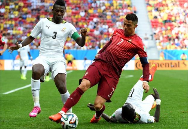 Asamoah Gyan and Cristiano Ronaldo at the 2014 World Cup