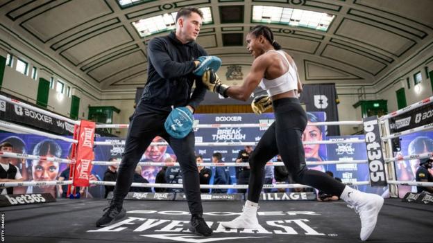 Shane McGuigan on the pads with his fighter Caroline Dubois