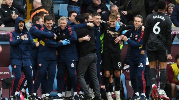 The Arsenal bench celebrates at Villa Park