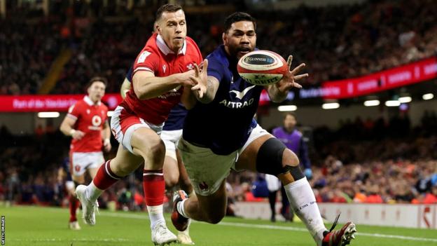 Romain Taofifenua of France scores his team's fourth try whilst under pressure from Gareth Davies of Wales