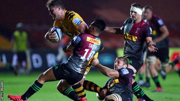 Will Rowlands of Wasps is tackled by Chris Robshaw and Marcus Smith