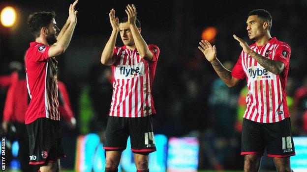 Exeter City players celebrate against Liverpool
