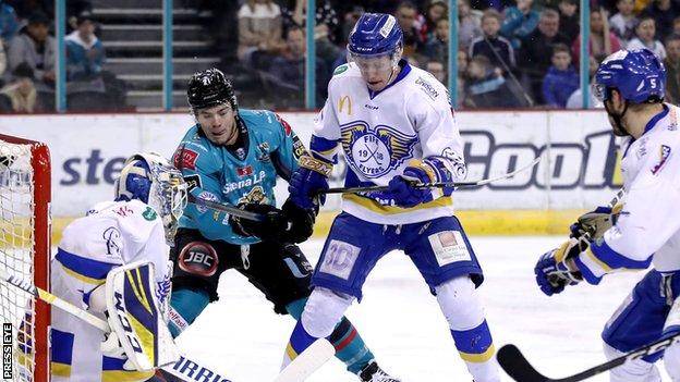 Liam Morgan of the Belfast Giants and Fife Flyers' Adam Morrison battle for possession
