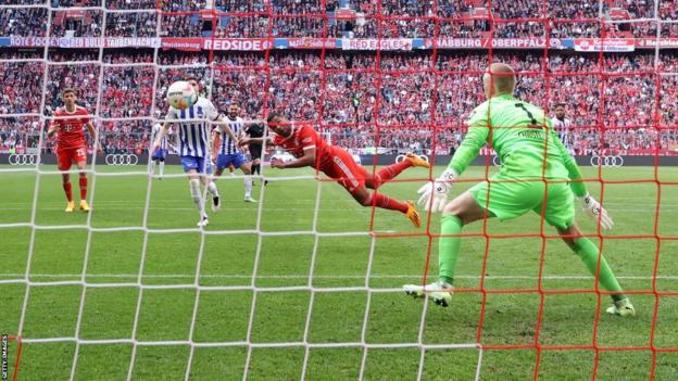 Serge Gnabry scores a diving header for Bayern Munich against Hertha Berlin
