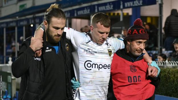 Jack Dixon is helped off the field against Leinster