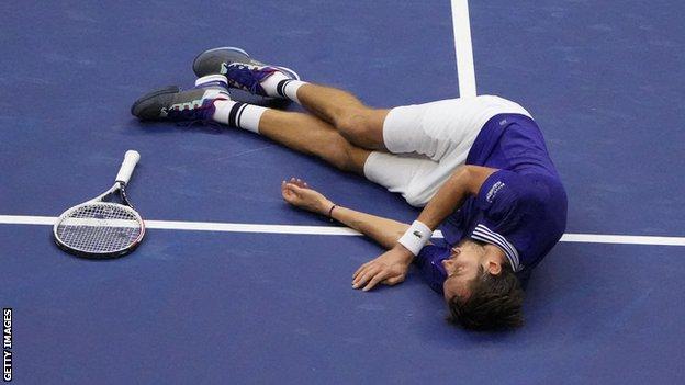 Daniil Medvedev falls to the ground in celebration