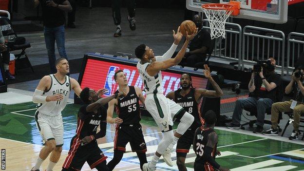 Giannis Antetokounmpo drives to the basket against Miami Heat forward Trevor Ariza (8) and guard Duncan Robinson (55) in the first quarter during game two in the first round of the 2021 NBA Playoffs