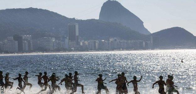 Competitors run into the sea at Copacabana beach