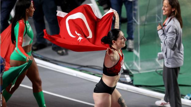 Tugba Danismaz celebrates after winning the triple jump for host nation Turkey