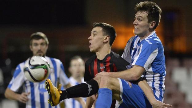 Crusaders winger Paul Heatley and Garth Falconer of Coleraine keep their eyes on the ball in Friday's league encounter at Seaview