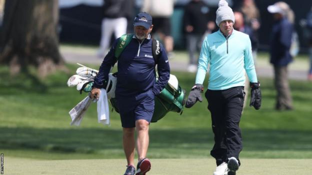 Matt Fitzpatrick and his caddie Billy Foster walking down a fairway at Oak Hill