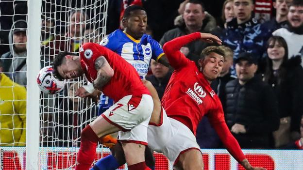 Neco Williams collides with Wales team-mate Brennan Johnson during Nottingham Forest's Premier League game with Brighton on 26 April