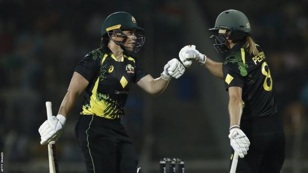 Grace Harris (left) and Ellyse Perry (right) fist bump during their partnership for Australia v India