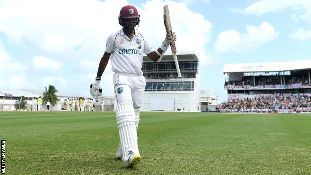 Kraigg Brathwaite raises his bat to the crowd in Barbados