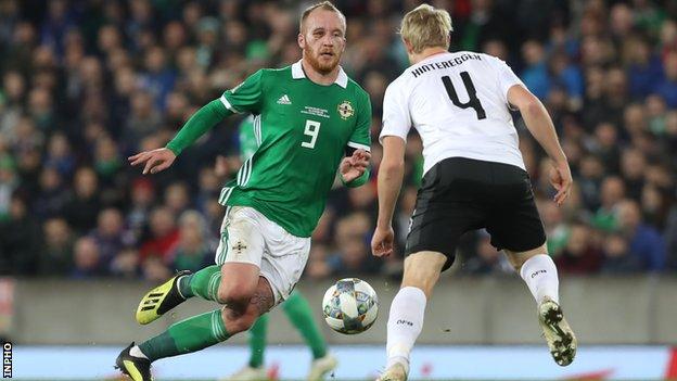 Northern Ireland's Liam Boyce is about to be challenge by Austria's Martin Hinteregger in the 2018 Nations League game at Windsor Park