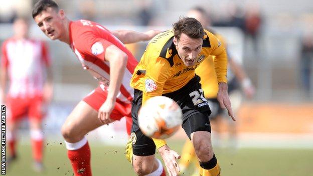 Alex Rodman of Newport County gets away from Matty Pearson