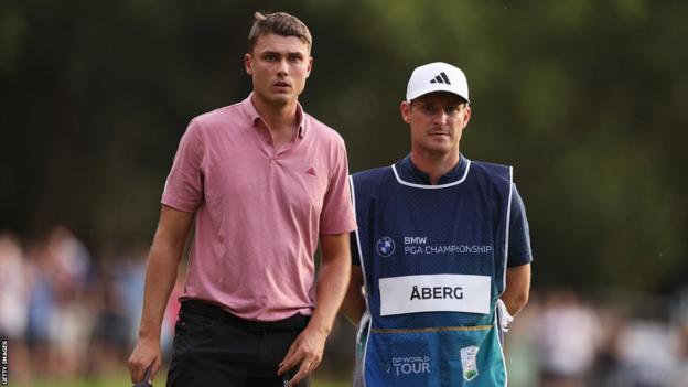 Ludvig Aberg on the fairway with his caddie