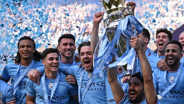 Manchester City players celebrate winning the Premier League