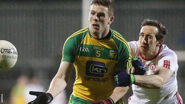 Donegal's Eoghan Ban Gallagher gets a tug from Tyrone midfielder Colm Cavanagh in Ballybofey