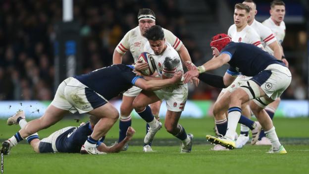 Marcus Smith is tackled against Scotland