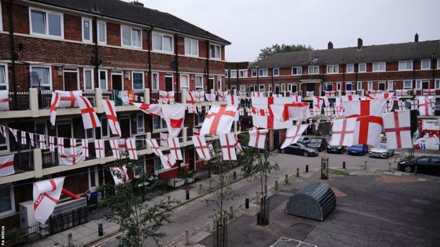 England flags and bunting hung crossed  the Kirby Estate successful  Bermondsey, southbound  London, successful  enactment    of the Lionesses earlier  the World Cuo final