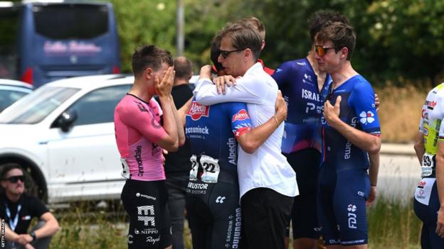 Riders at the Tour de Suisse console each other after learning of Gino Mader's death