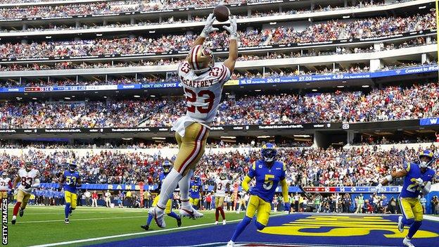 Christian McCaffrey leaps to catch one of his touchdowns