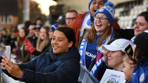 Sam Kerr of Chelsea poses for a selfie with fans