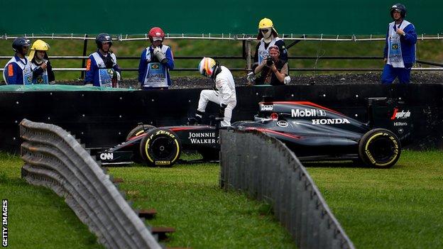 Fernando Alonso gets out of his McLaren during qualifying for the Brazilian Grand Prix in 2015