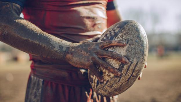 a rugby league player holding a ball