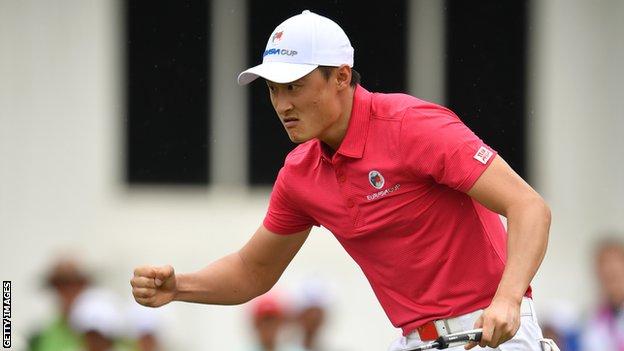 China's Li Haotong celebrates a birdie putt during day one of the EurAsia Cup in Malaysia