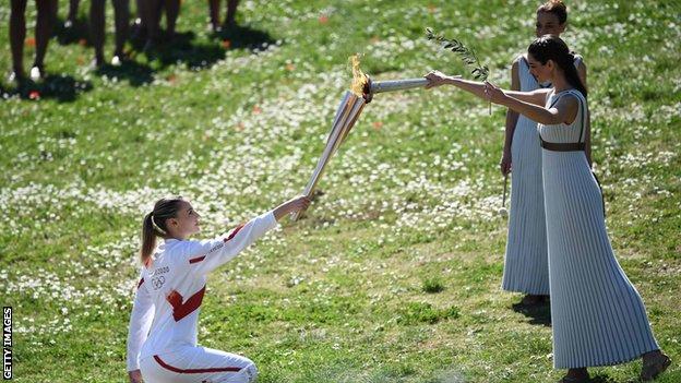 Greece's Anna Korakaki receives the Olympic flame