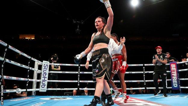 Chantelle Cameron raises her hand in victory