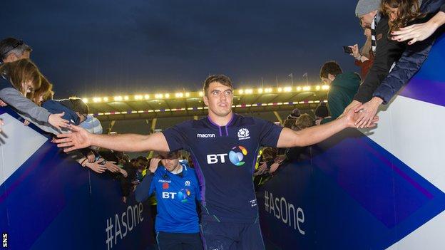 Sam Skinner high-fives Scotland supporters after his team beat Fiji