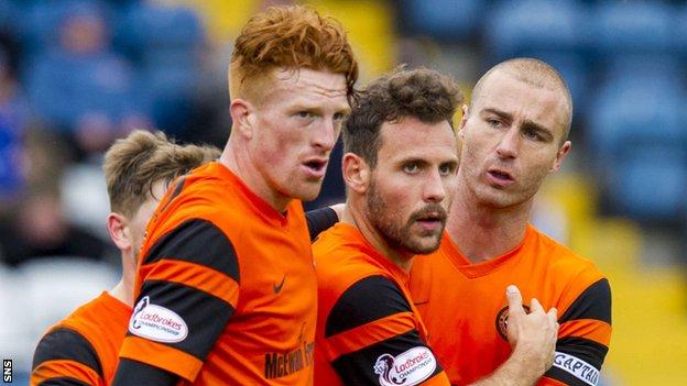 Dundee United celebrate the winner by Tony Andreu (centre)