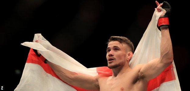 Nathaniel Wood unfurled an England flag after his victory, scaling the octagon