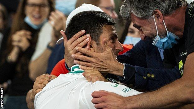 Novak Djokovic celebrates with his team