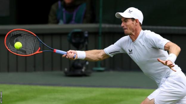 Andy Murray hits a return during practice at Wimbledon