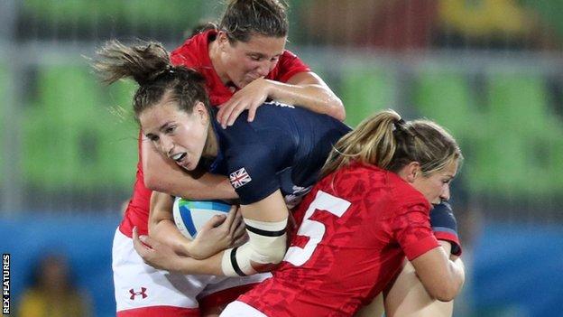 GB women's captain Emily Scarratt is tackled by Canadain players