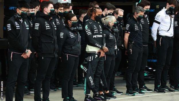Lewis Hamilton and the Mercedes team hold a minute's silence before qualifying at Imola